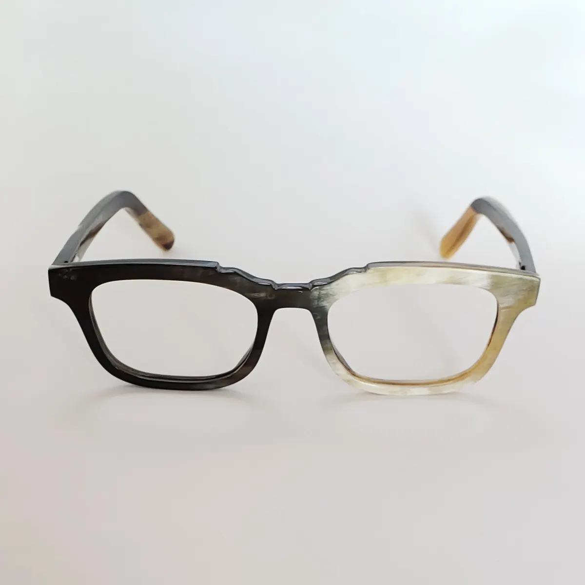 Black and ivory buffalo horn Garden Road frame on a pale background
