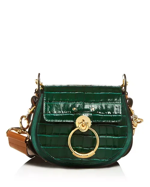 Green crocodile handbag with gold hardware on a white background