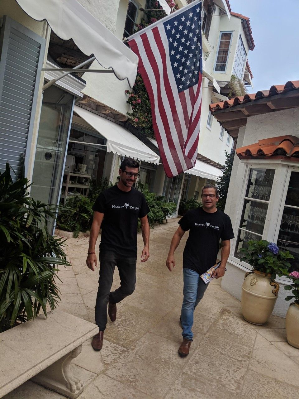 Harvey Taylor team members walking through a Palm Beach courtyard